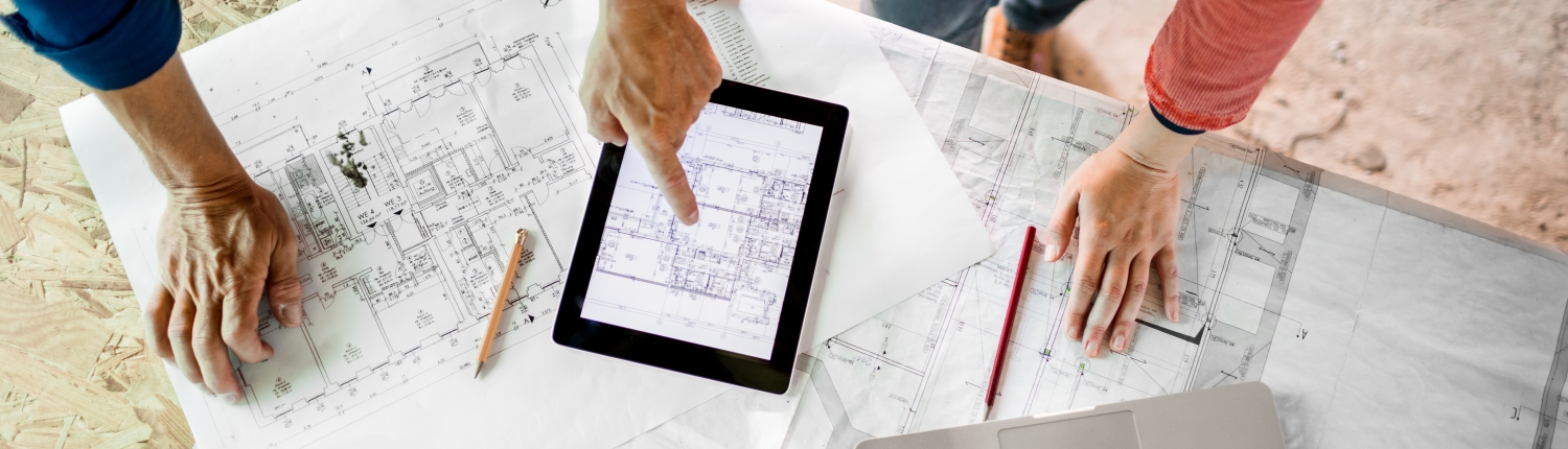 Architect And Construction Worker With Plans, Tablet PC And Laptop