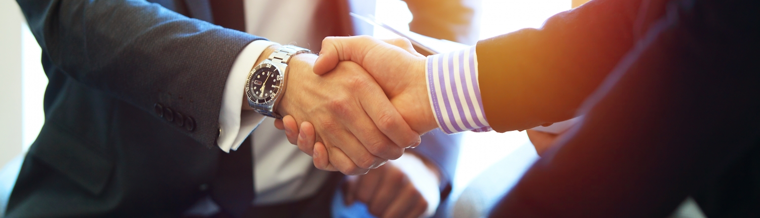 Business people shaking hands, finishing up a meeting.