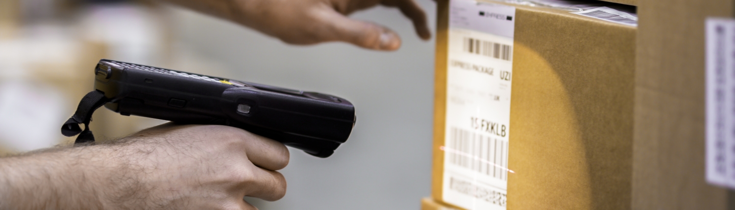 Manual worker scanning cardboard box